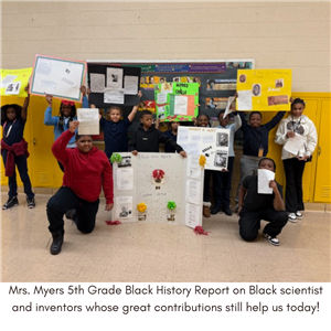 5th Graders holding science projects.